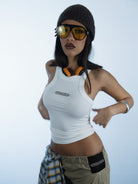 Person wearing a white silver logo tank top