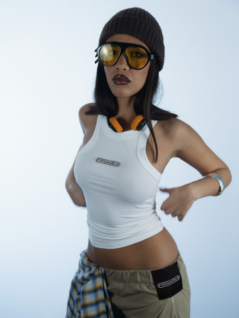 Person wearing a white silver logo tank top