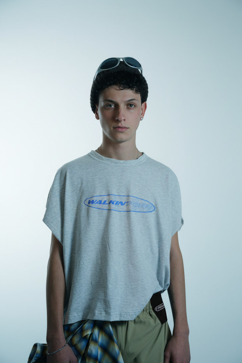 Person wearing a 'Walkin'Porn' t-shirt with a plain background