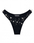 Black thong with embellishments and spikes on a white background